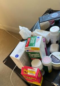 bedside table full of medications taken during COVID illness